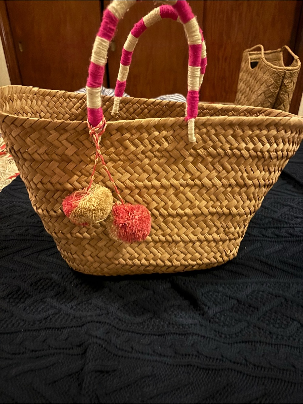 Handwoven Straw Tote with Pink-Wrapped Handles and Pink/Cream Pom Accent